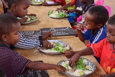 Young students eating their school meals at lunch time in Somalia